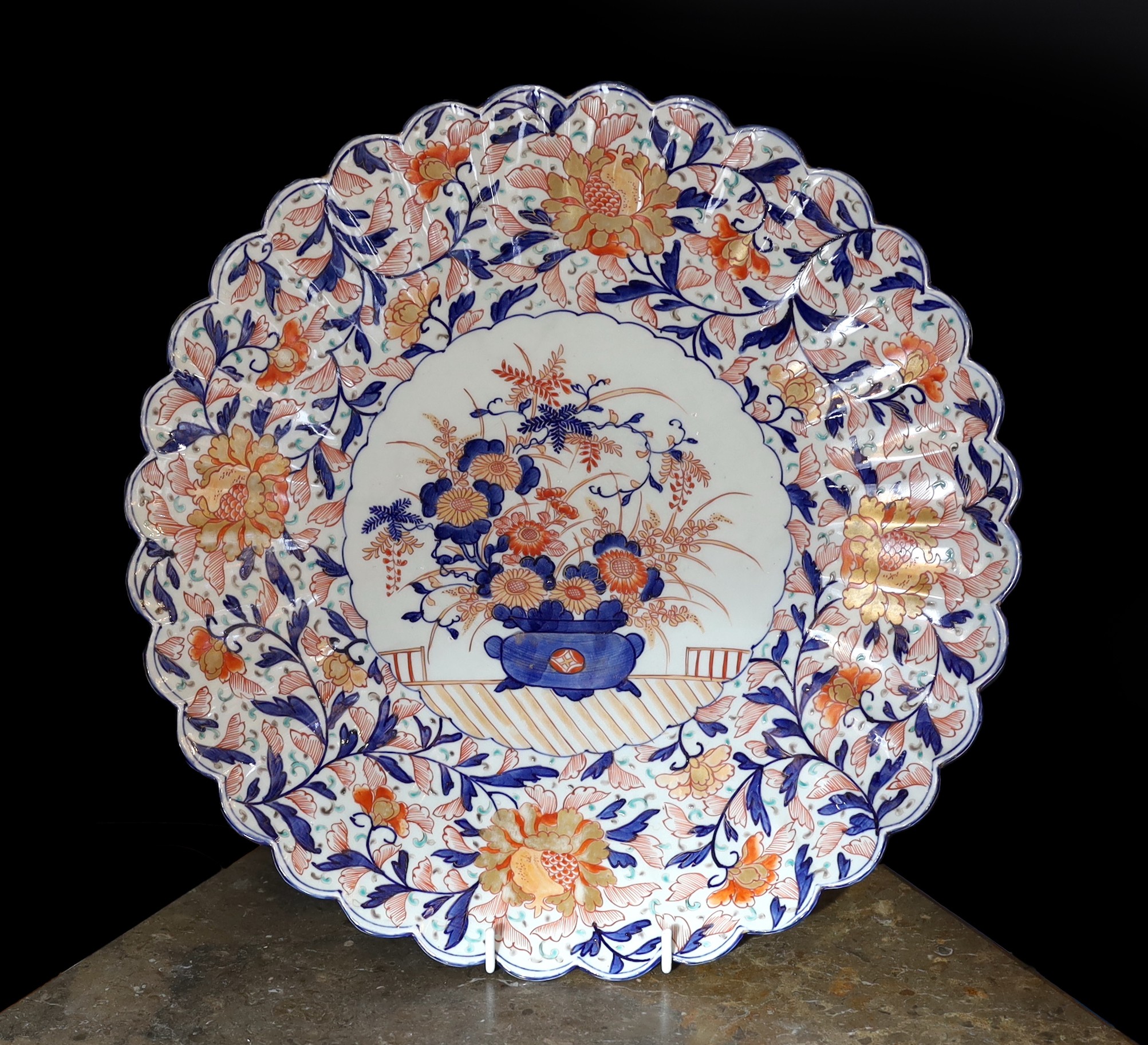 An Imari charger decorated with a central panel of flowers in a vase within floral borders, diameter 47 cm